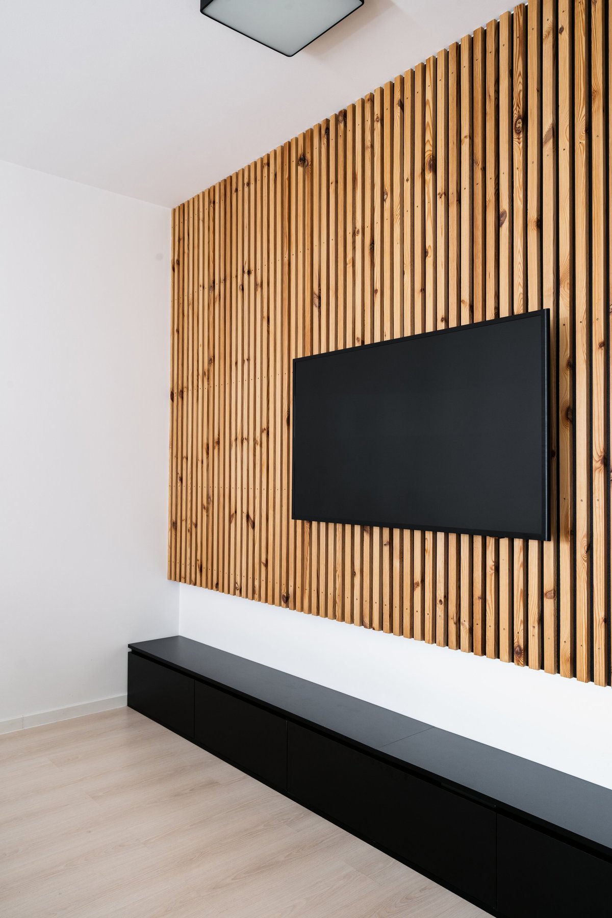 Flat screen television mounted on wall in a contemporary living room with modern interior design