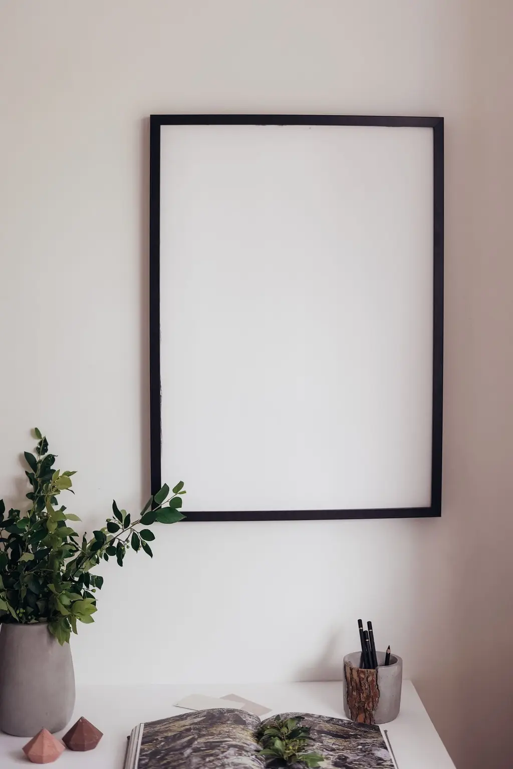 Blank picture frame on a wall, clean interior background