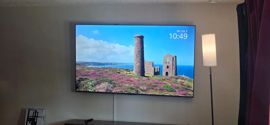 Flat TV wall mount in a bright living room with a clean, level install