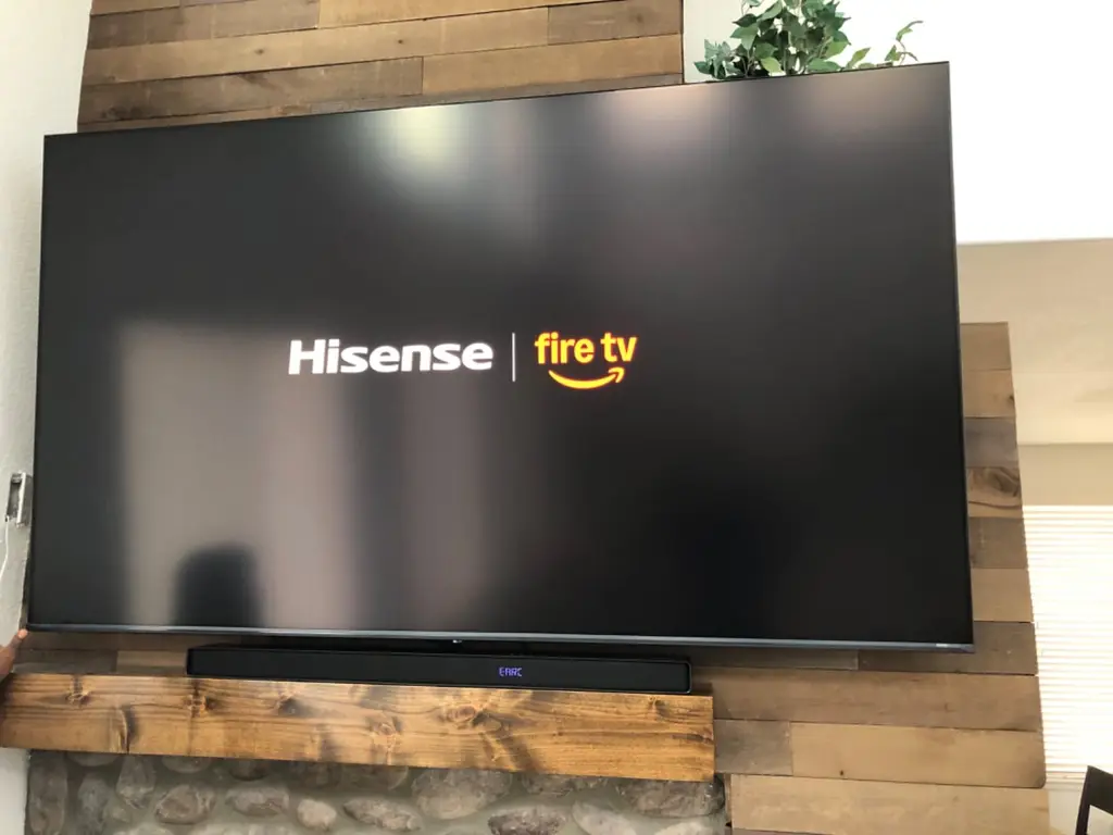 Hisense TV and soundbar mounted on a rustic wood plank wall in a Golden, CO home