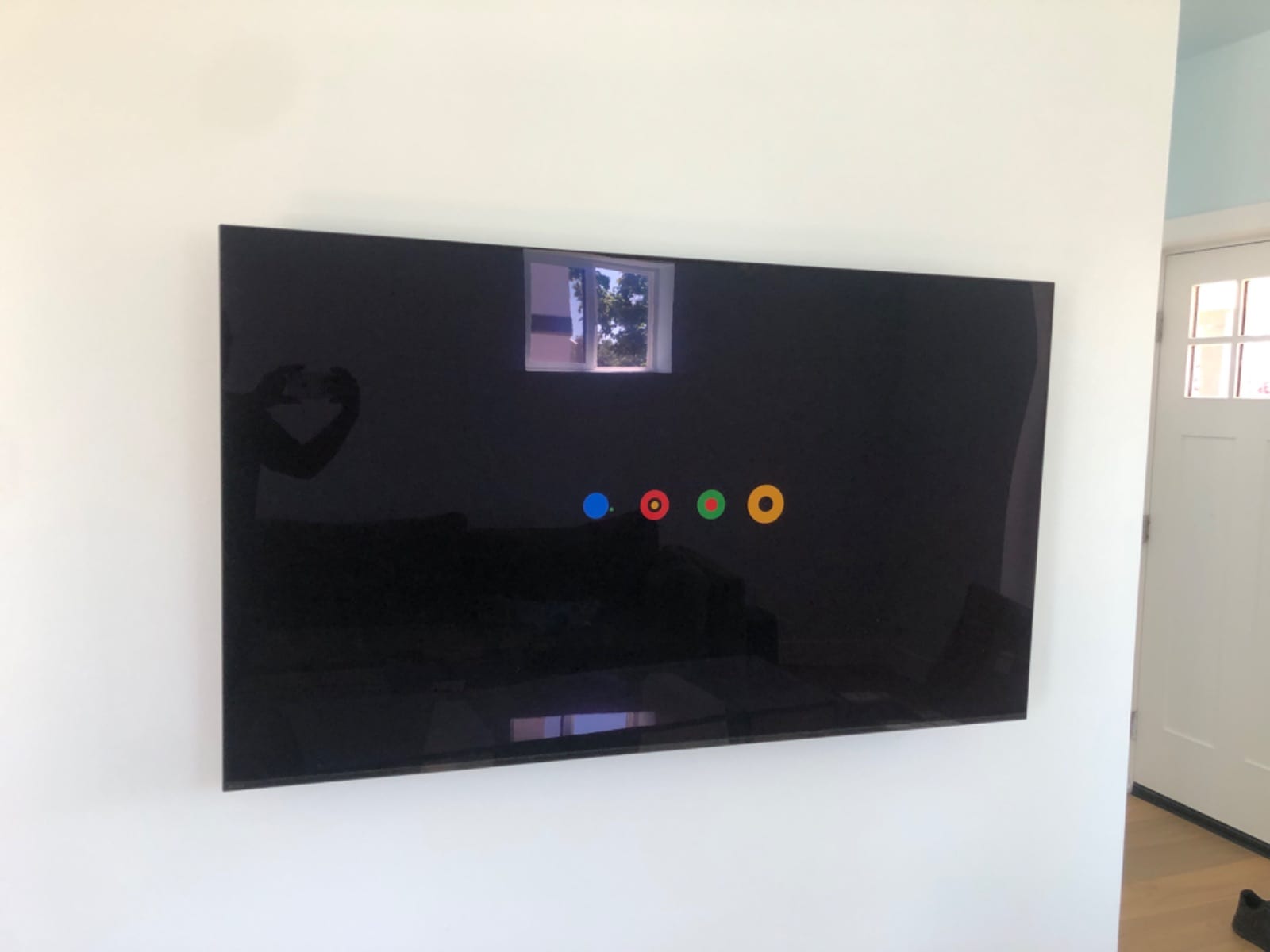 Large flat-screen TV mounted close to a plain white wall with no cords showing