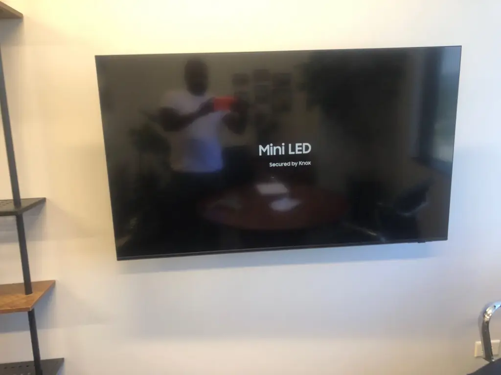 Large TV wall mounted in a living room