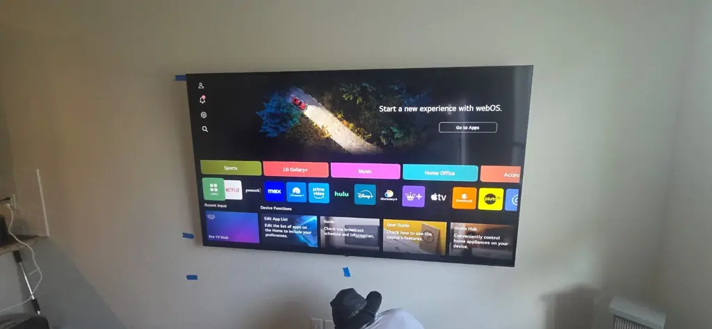 LG webOS TV freshly wall mounted and powered on for setup