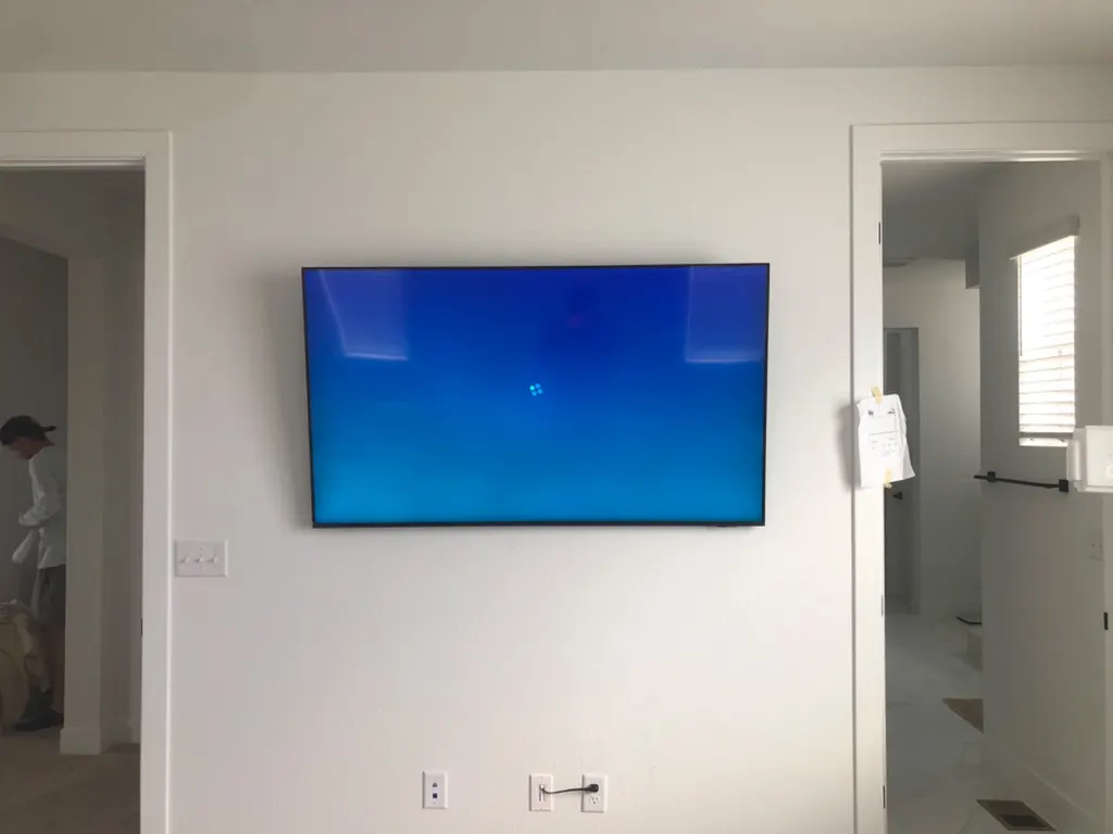 Flat TV mounted close to a white wall with a clean finish