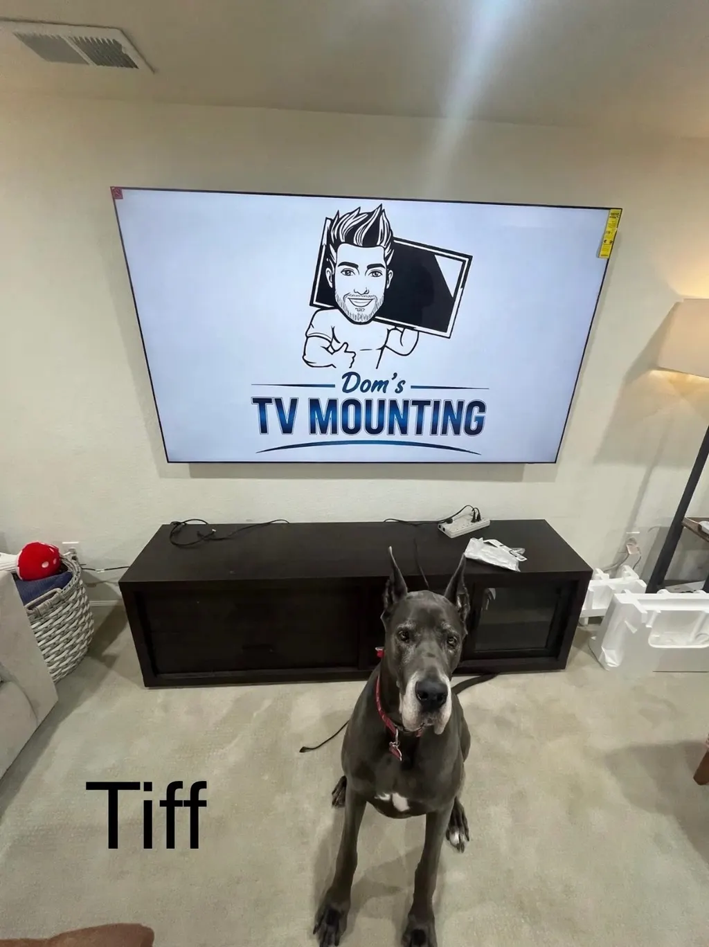 TV mounted on the wall above a media console