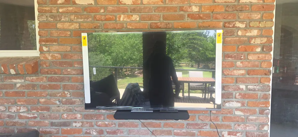 TV mounted on an exposed brick wall