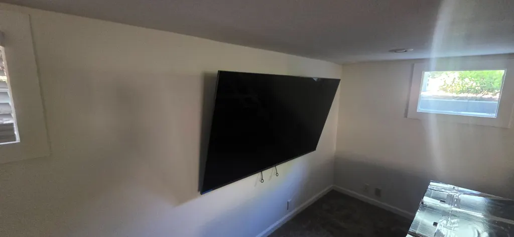 TV mounted on a wall in an upstairs room