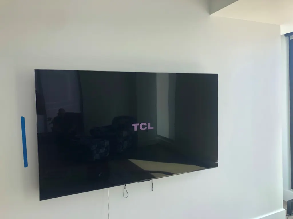 Flat TV mounted on a living room wall