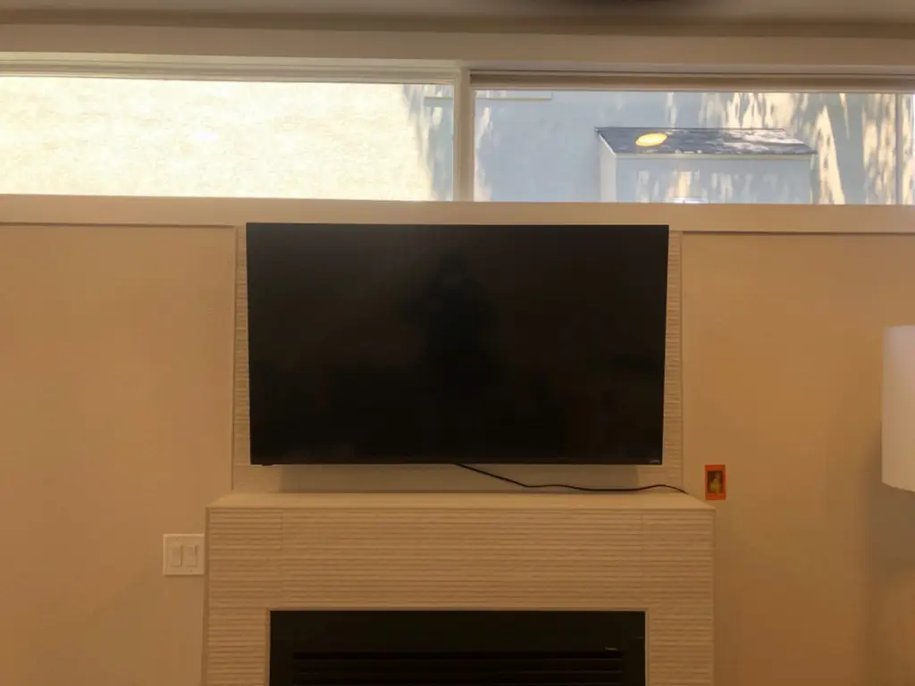 TV mounted above a tiled fireplace surround in Lakewood