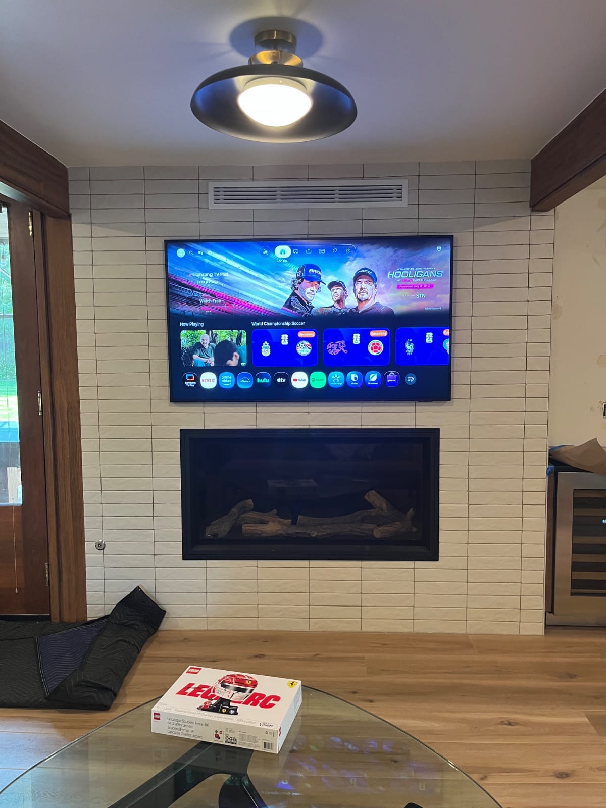 TV mounted above a tiled fireplace with wires hidden