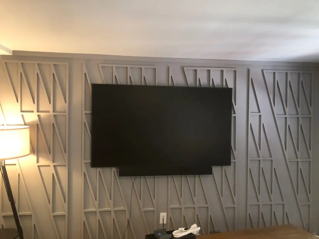 TV mounted on a geometric wood slat accent wall in a Boulder, CO home