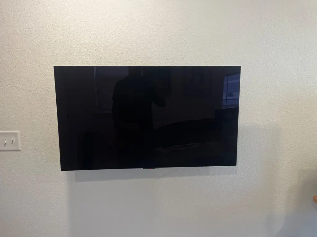 TV mounted with a low-profile bracket on a living room wall in Westminster