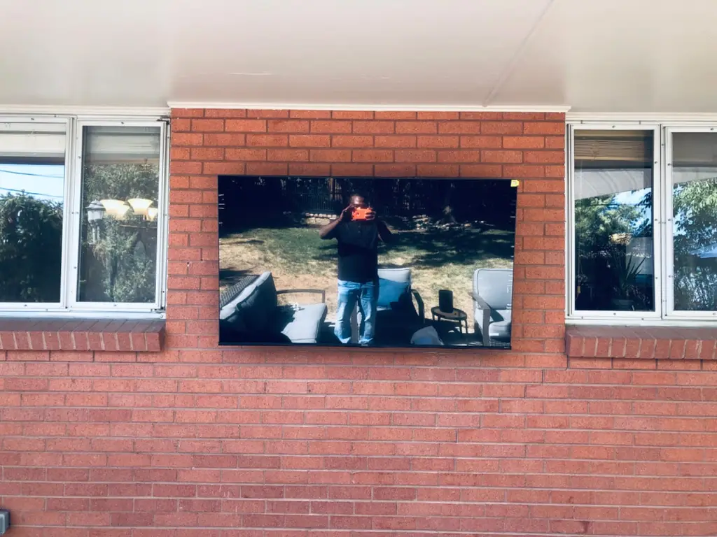 TV mounted on a brick wall
