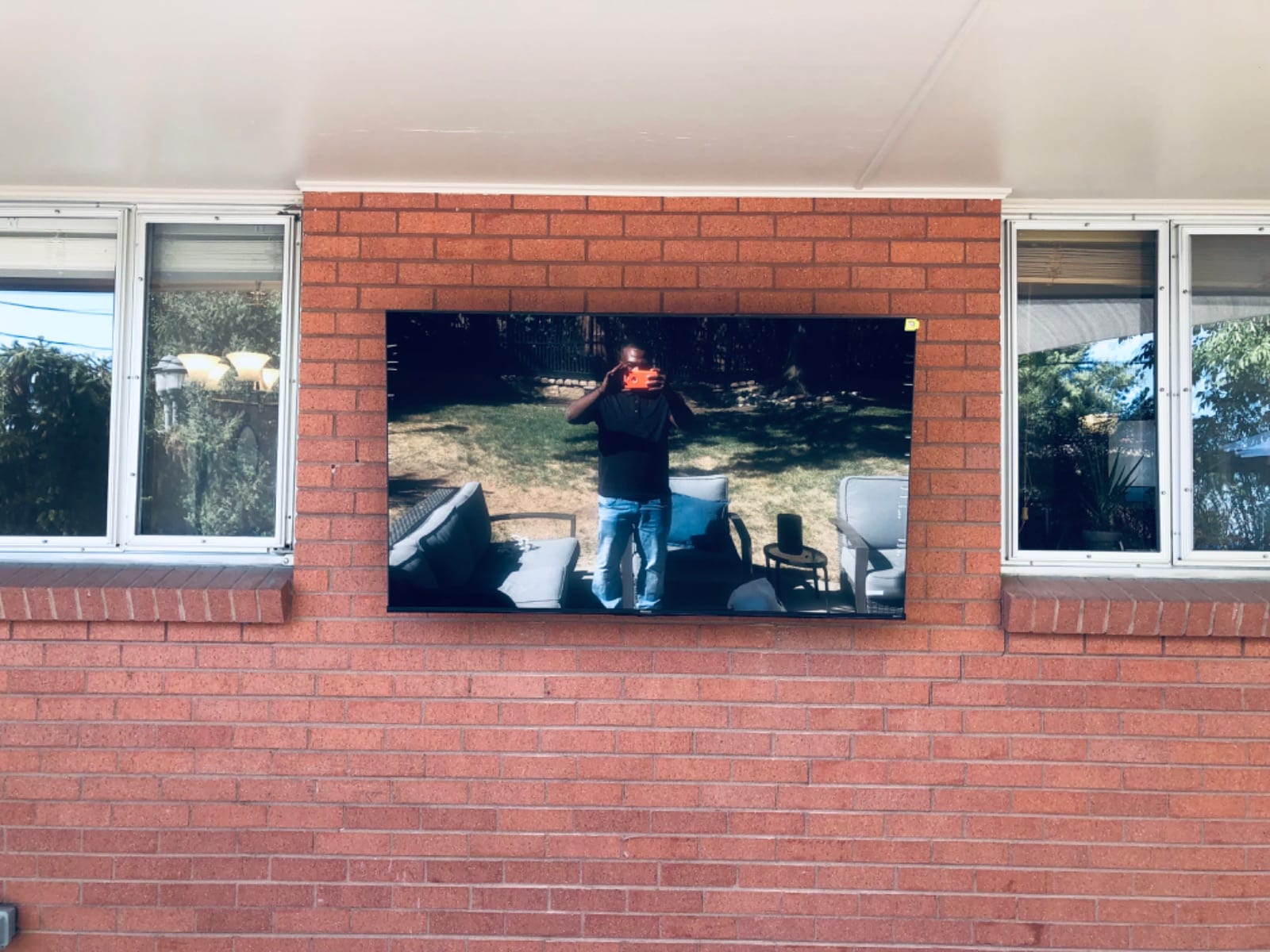 TV mounted on a brick wall