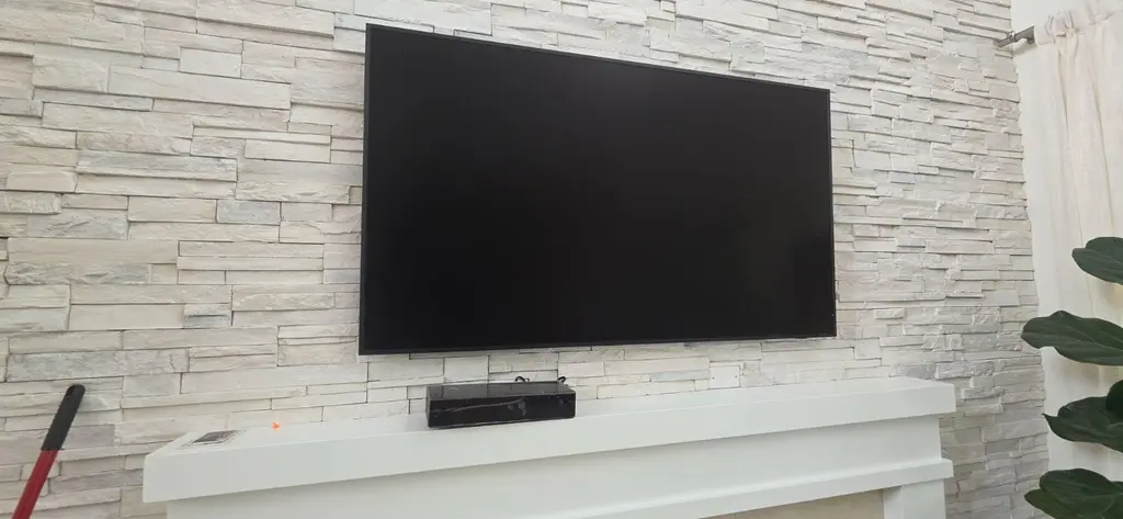 TV mounted on a white stacked stone wall in Aurora, Colorado