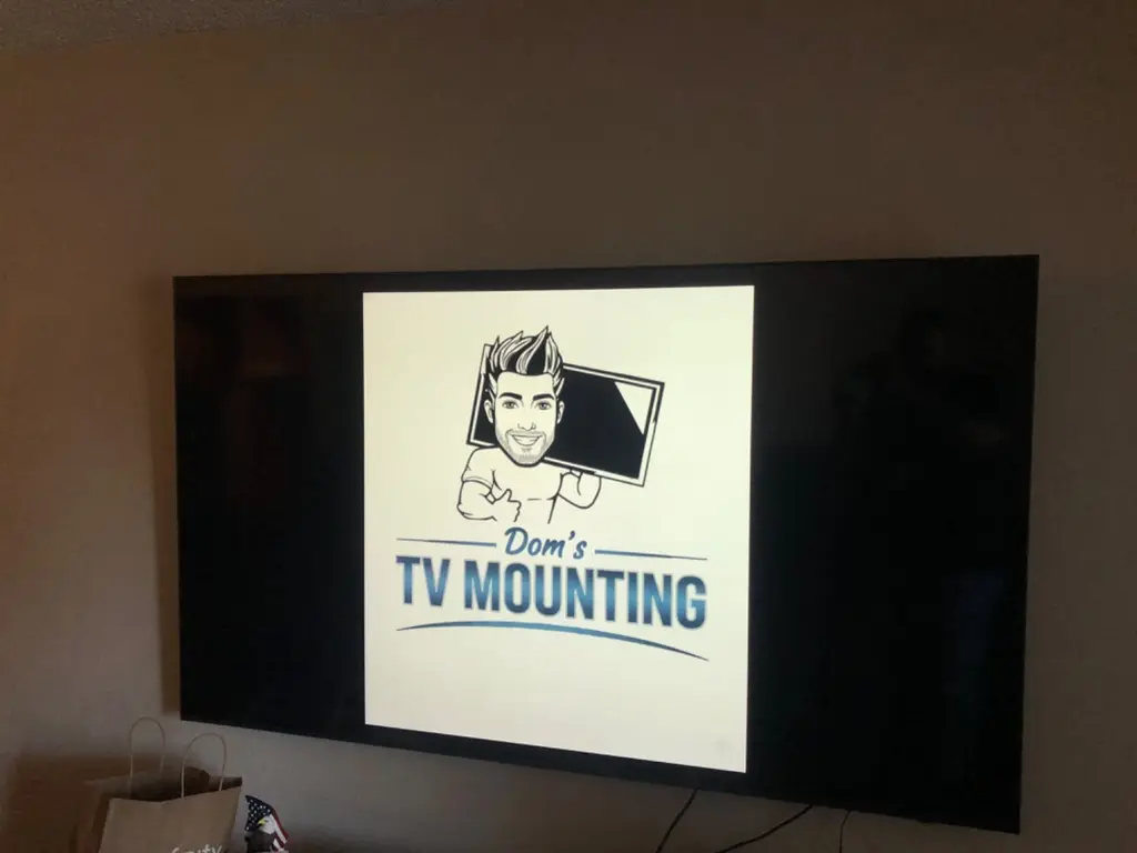 Wall-mounted TV with a soundbar installed below it