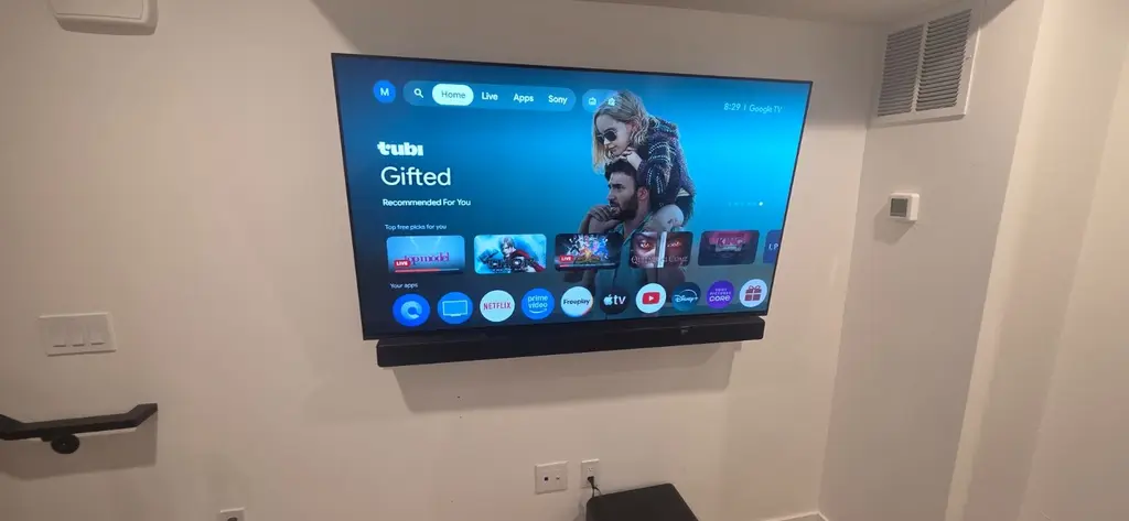 TV and soundbar wall mounted in a finished basement in Lakewood