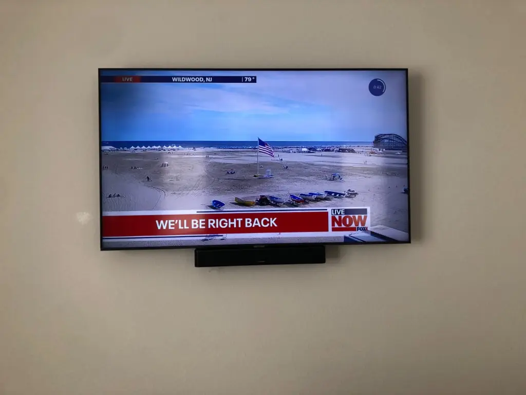 TV with soundbar mounted below in a Centennial, CO living room