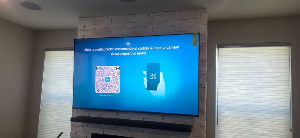 TV and soundbar mounted on a stone fireplace wall between windows in Broomfield, CO
